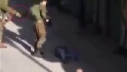 Watch how Israeli soldiers are Planting of a weapon at the crime scene after killing innocent Palestinian - X99TV