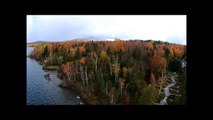 Drone captures autumn snowstorm crossing Canadian lake