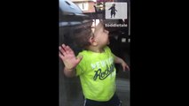 Toddler tries to eat food through window
