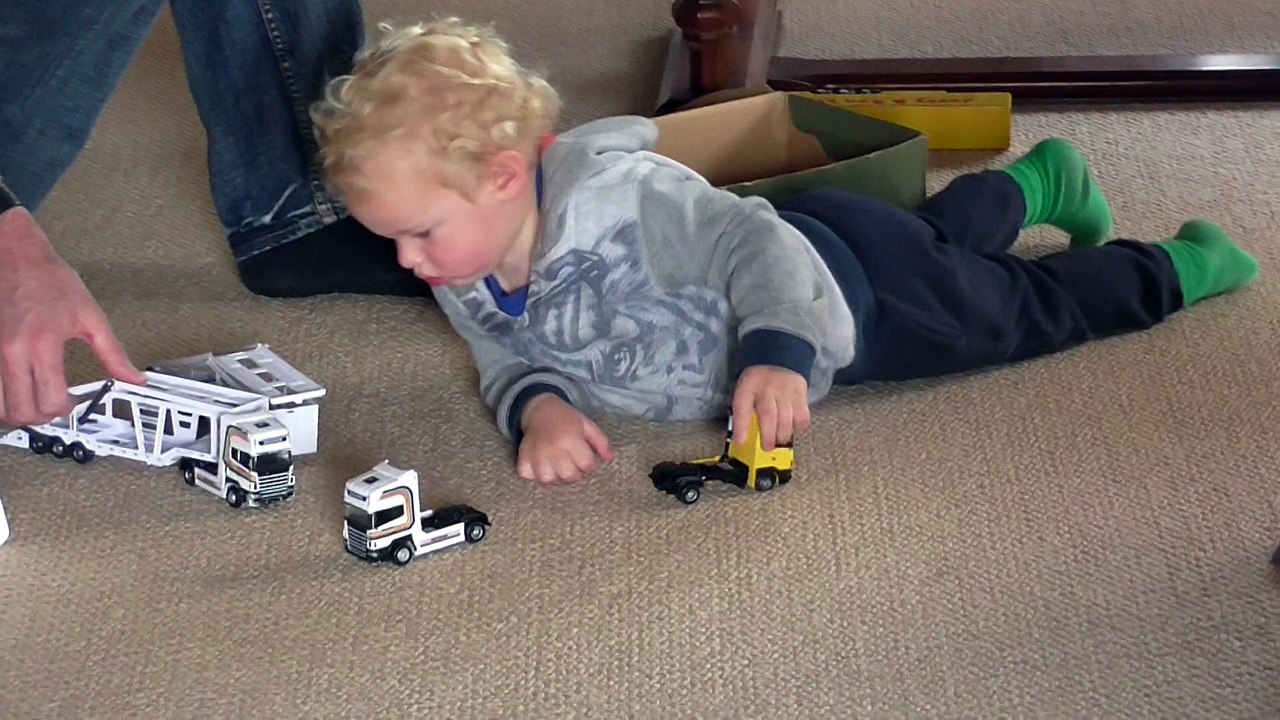 Jarom playing with the trucks