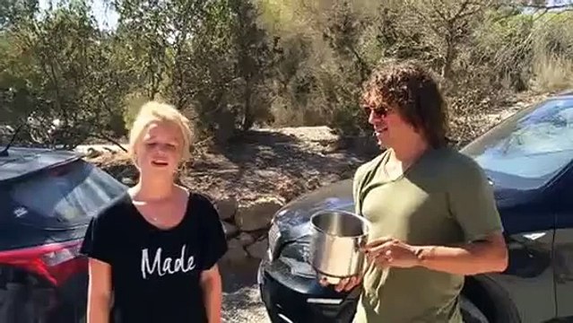 Barcelona legend Carles Puyol helps an attractive blonde do the ALS challenge in Ibiza