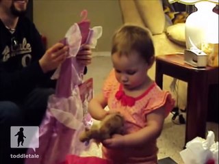 Little girl tries to ride her toy horse