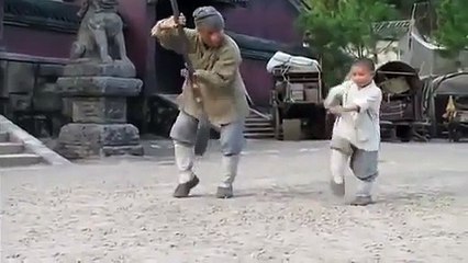 A Shaolin kid teaching Jackie Chan a staff routine