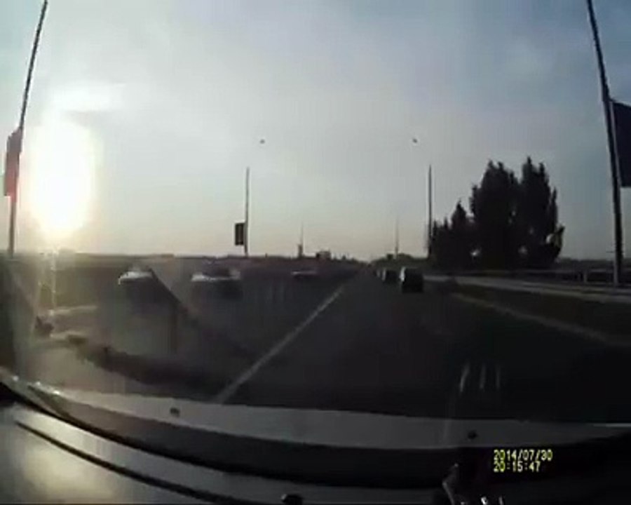 Shocking highway motorcycle crash ends with rider sitting comfortably on the roof of someone else's car