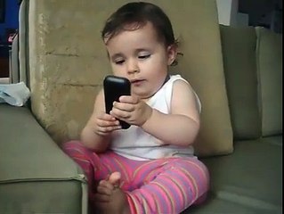 cute baby pretending to talk on the phone