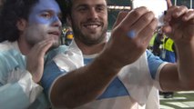 Argentine players and fans pitch-side post-match