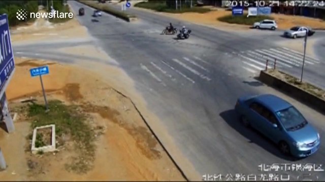 Scooter bursts into flames after crashing into car