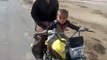 A 2 year old baby riding a bike in Pakistan - Very Dangerous