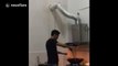 Cooking man's hilarious reaction to falling pipe
