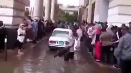 Alexandria man carries people across rain filled street for 1 EGP