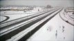 Snow Owl flies over Canadian Highway gets filmed by Traffic Camera