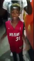 Kid has an extremely flexible neck. Kid hugs person behind him.