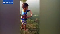 Young Boy Goes Fishing with a Tiny Toy Fishing Rod and Actually Catches a Fish