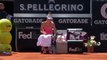 Tennis ballboy stacks it while reaching for Maria Sharapovas parasol