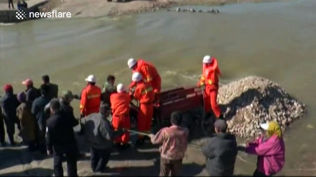 Firefighters rescue people trapped in rushing river