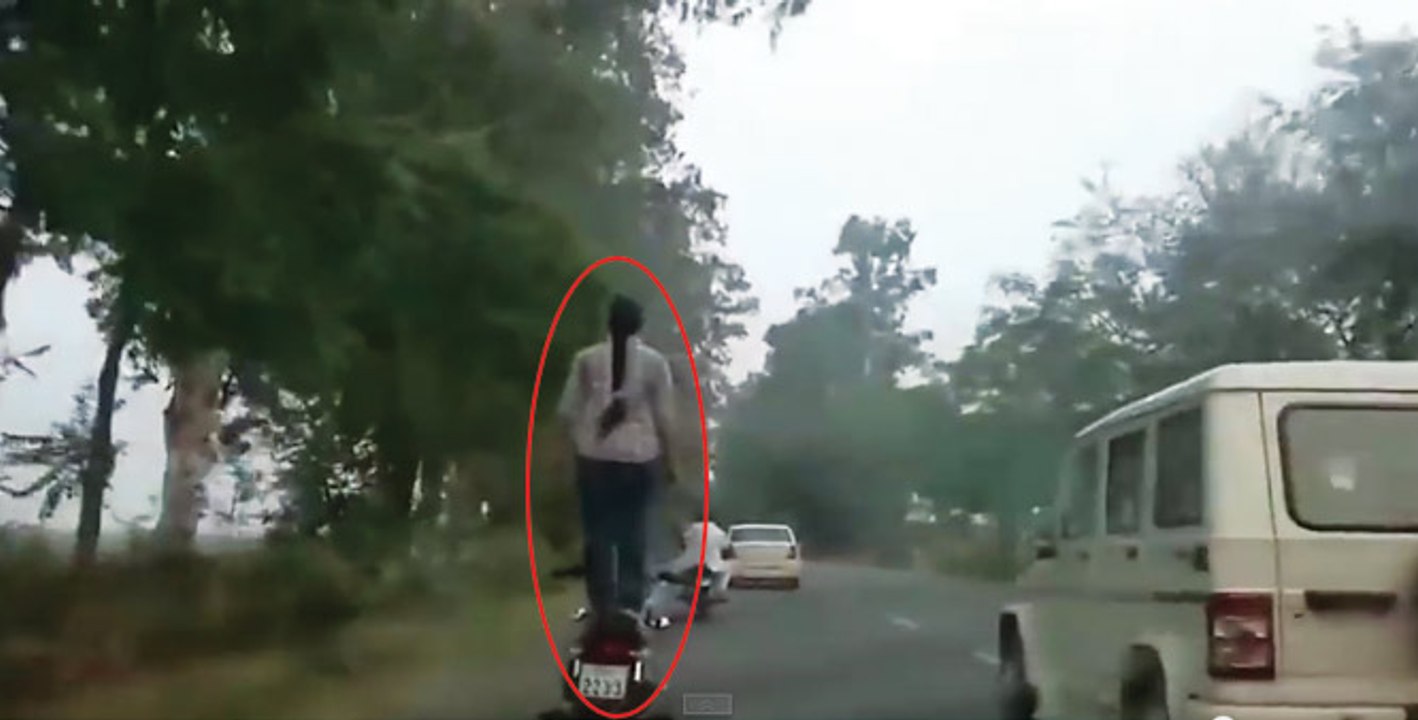 Watch this lady, and learn how to drive a bike