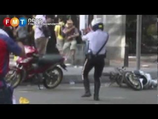 New video: Cop points gun at protestor