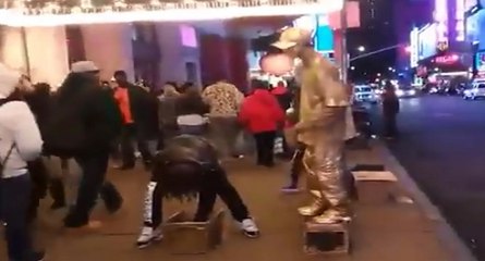 Un homme statue met un méchant coup de pied à un voleur