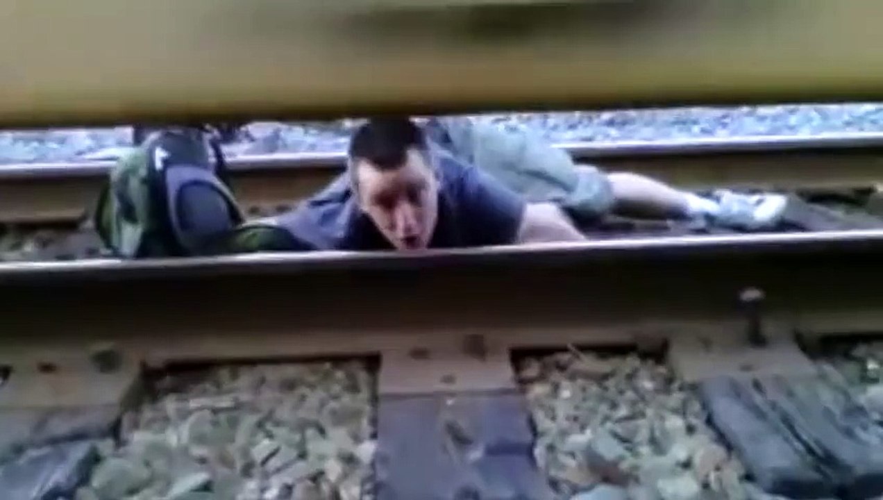 Guy Lays Under Moving Train  What Was He Thinking!