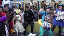 Clowns give refugees a chance to smile in Greece