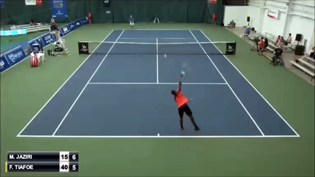 Frances Tiafoe misses the ball near the net