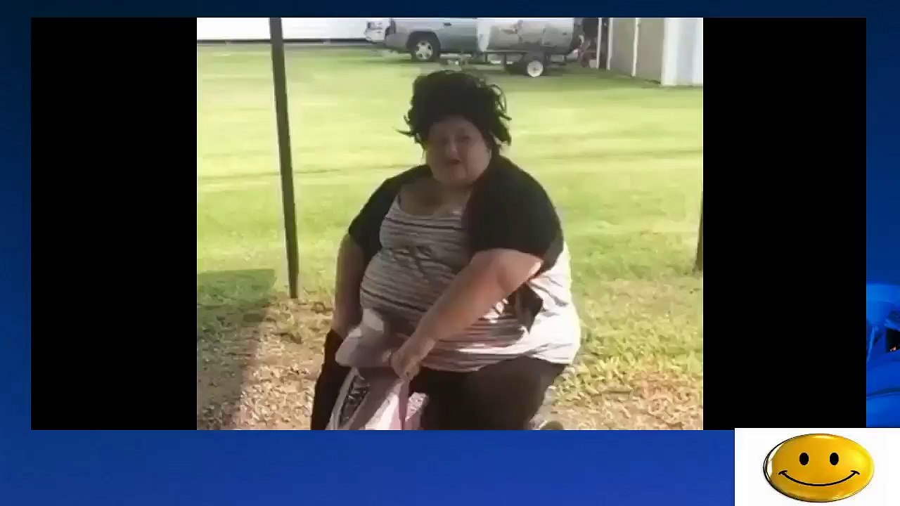 A fat woman sit on a tricycle for children 2015