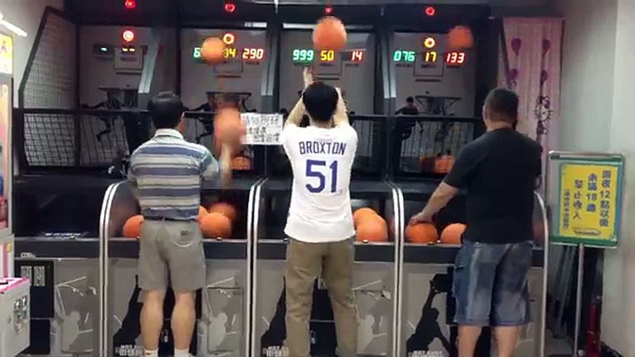A man throwing basketballs at the attraction without a miss