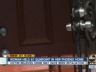 Woman held at gunpoint in Phoenix home