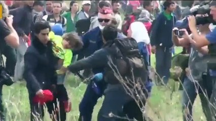Camerawoman SACKED after filmed kicking migrant carrying CHILD