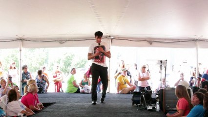 Joseph Hall takes a video of the tent crowd at Elvis Week 2014