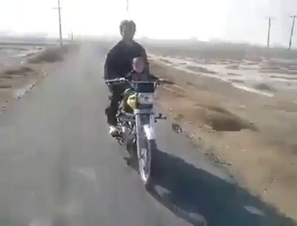 A 2 year old baby riding a bike in Pakistan - Very Dangerous