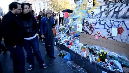 People lay flowers for Paris terror attacks victims