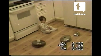 Little boy attempts to have all pan lids spin at same time