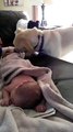 That dog can't understand why the baby is not covered. So he takes over the same even