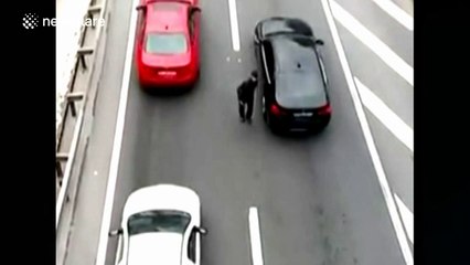 Man hands leaflets in the middle of a really busy road