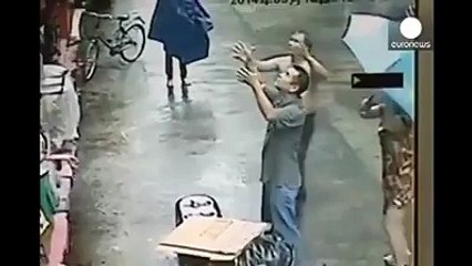 Two men catch a baby that fell out of a window..