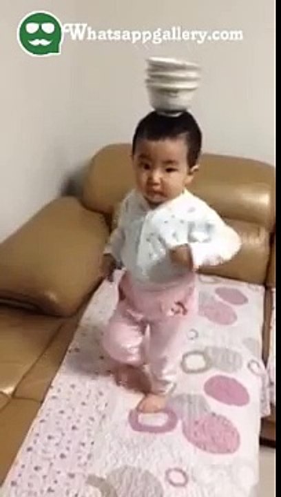 whatsapp funny videos cute baby dancing while balancing cup on head-Xr6IUntvvAg