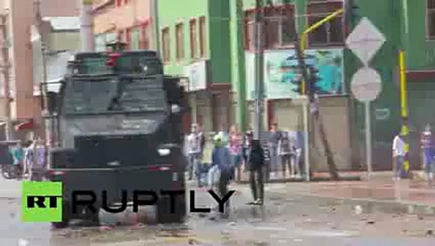 Clashes water cannons tear gas reign as police seize illegal contraband in Bogota