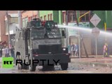 Clashes, water cannons & tear gas reign as police seize illegal contraband in Bogota