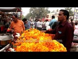 Street vendors sell flower garlands ahead of Diwali in Agra