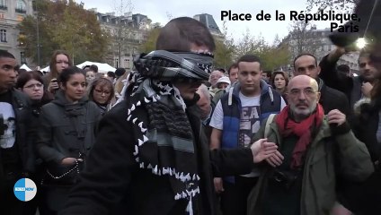 Blindfolded Muslim man with sign “Do you trust me” hugs hundreds in Paris
