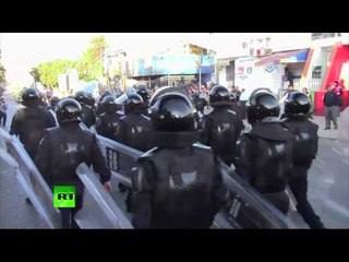 Stones & plumes of tear gas as Mexican police clash with dissident teachers