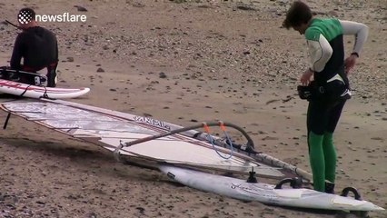 Windsurfers brave powerful Storm Clodagh wind off the coast of Cornwall, UK