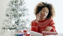 Young African Woman Wrapping Gifts At Christmas | Stock Footage - Videohive