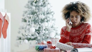 Young African Woman Wrapping Gifts At Christmas | Stock Footage - Videohive
