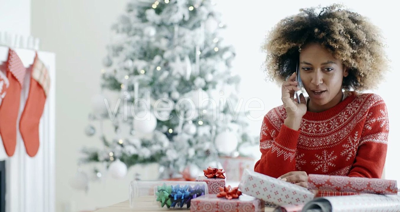 Young African Woman Wrapping Gifts At Christmas | Stock Footage - Videohive