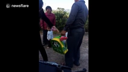 Granddad carries granddaughter in a sack to school bus stop