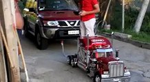 Truck model pulls owner and a car