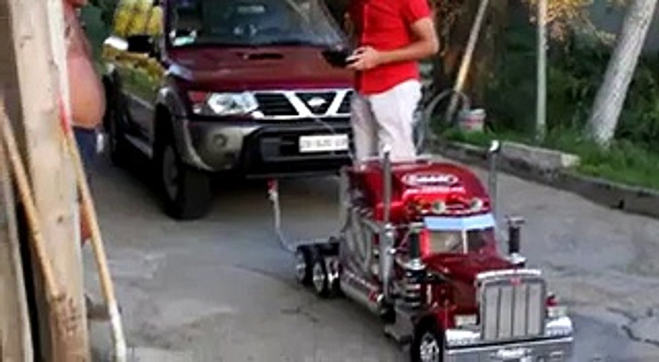 Truck model pulls owner and a car