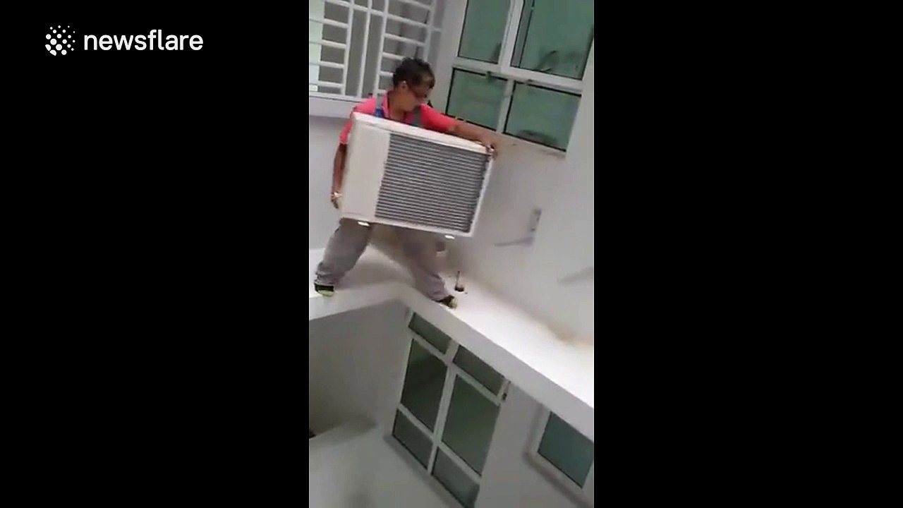 Man installs air conditioner unit outside 16th floor without wearing a harness